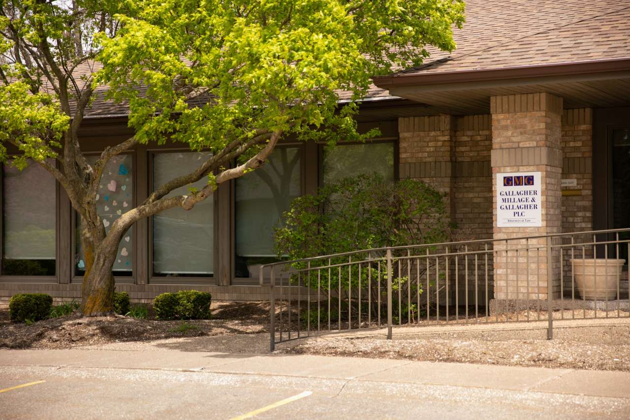 Photo of the GMG logo on a wall behind a desk area.